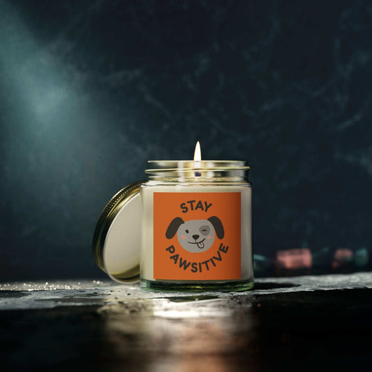 Leanne Roberts Designs Stay Pawsitive scented candle in clear glass jar with gold lid, coconut apricot wax, and cotton wick burning.