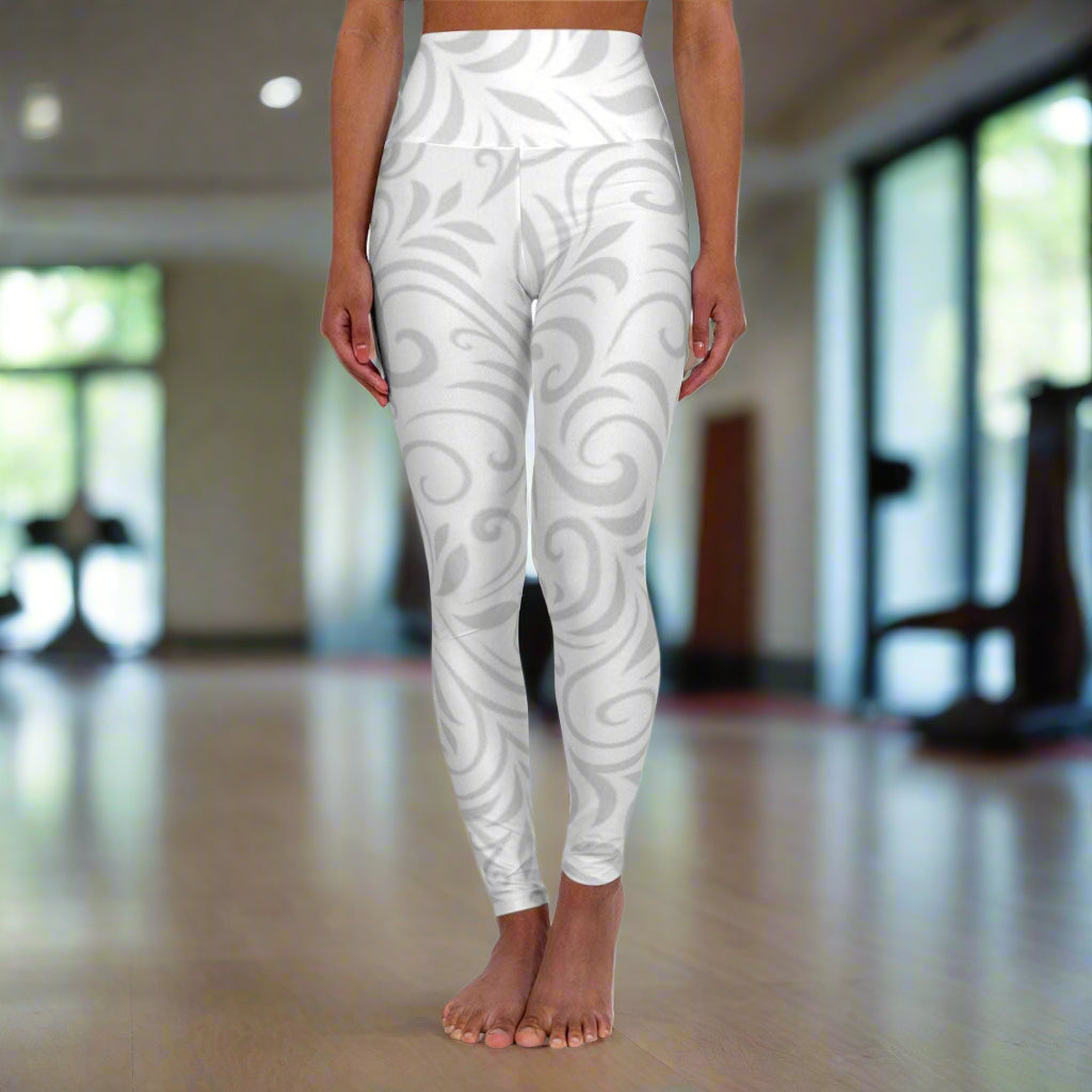 High waisted yoga leggings with elegant swirl pattern and high-rise waistband for comfortable activewear.