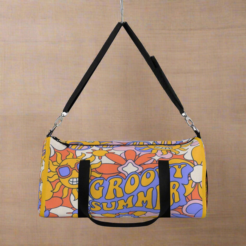 Colorful duffel bag with 'Groovy Summer' text and floral design on a white background