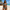 Woman wearing Ocean Wave Women's Bikini on beach with thatched hut and ocean background